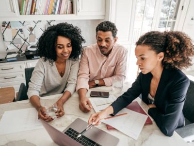 An accountant explaining insurance options to a couple.